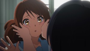 This time, Reina presses Kumiko's cheeks.